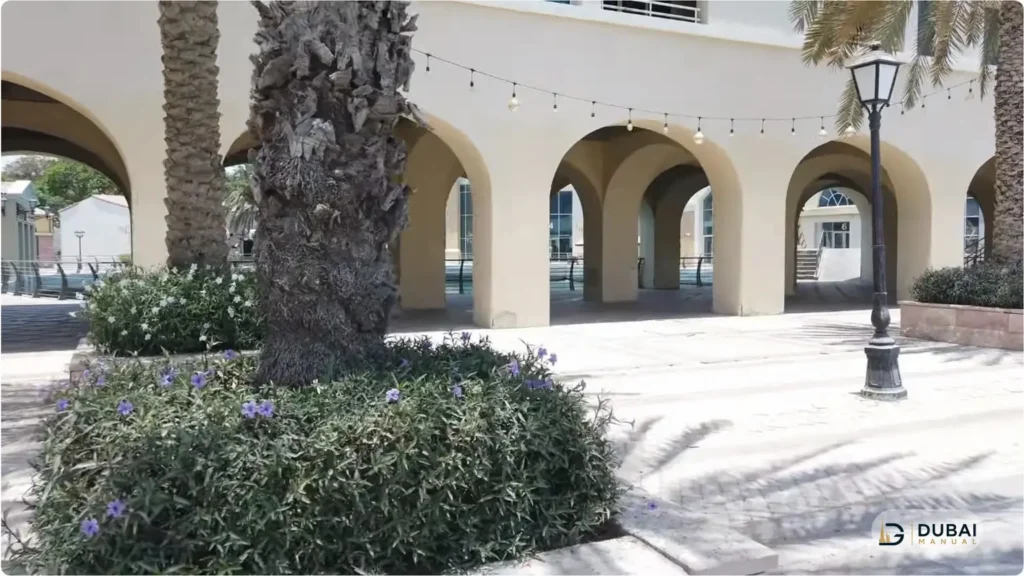 Arched retail courtyard with palm landscaping in Green Community