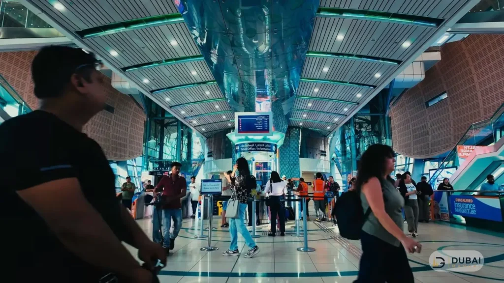 Busy Dubai Metro station concourse with Ticket Office and departure board