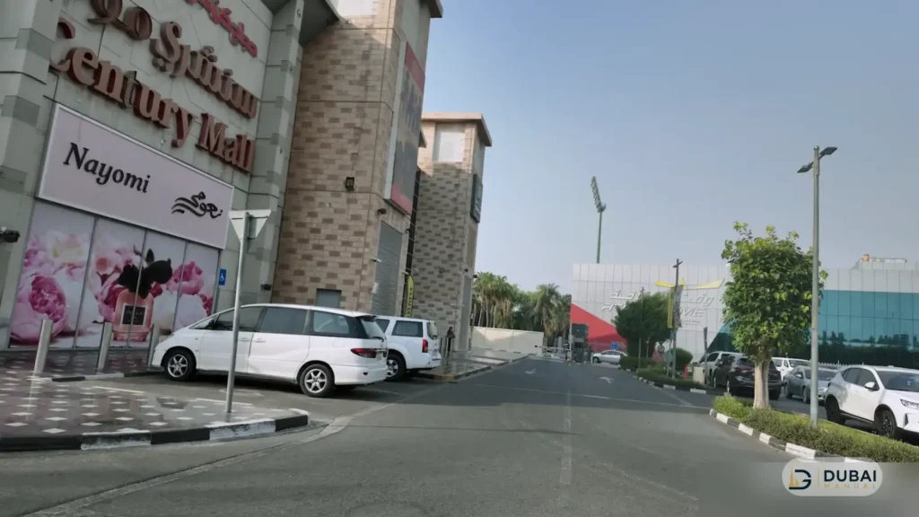 Century Mall exterior facade with storefronts and parking area