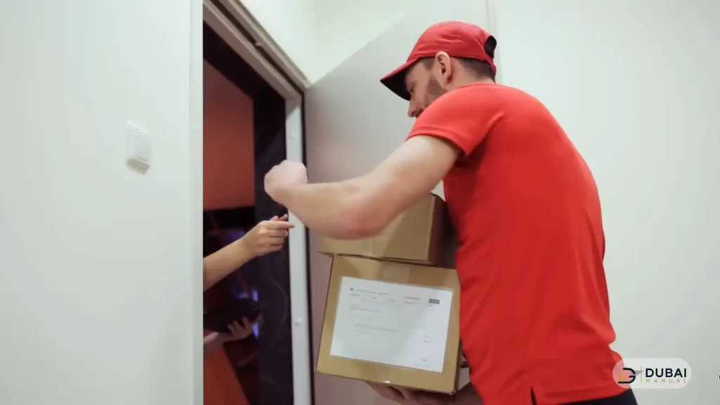courier handing parcel at building entrance Dubai