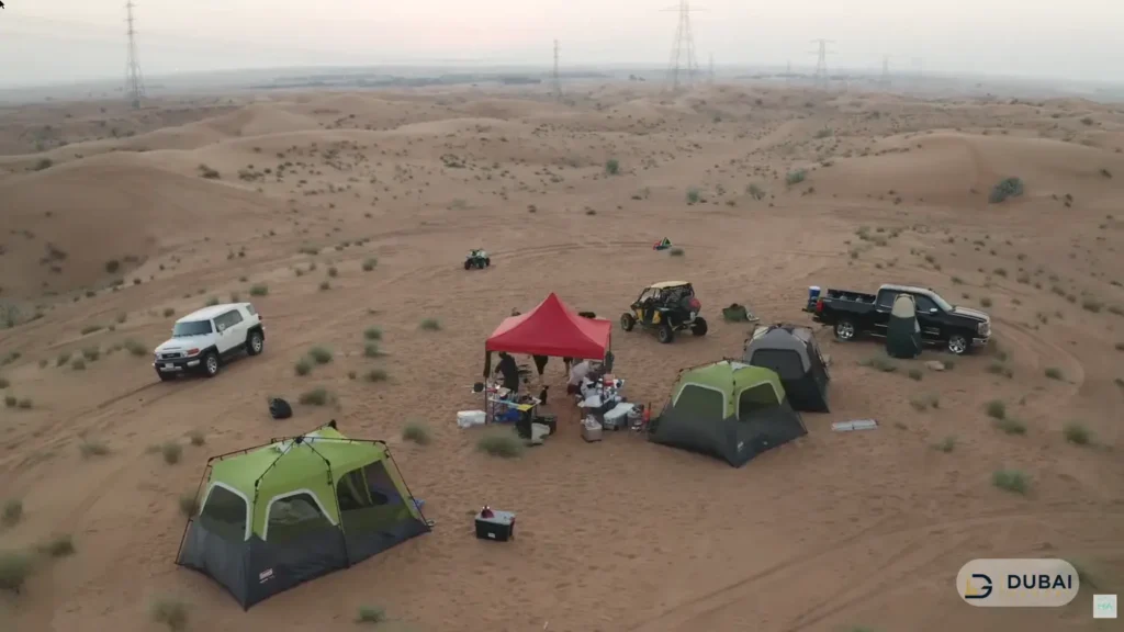 Desert campsite with tents and 4x4s near Fossil Rock