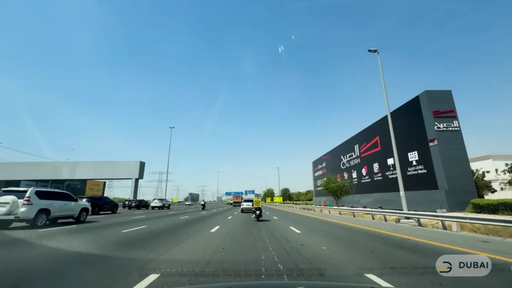 Dubai highway with blue directional road signs