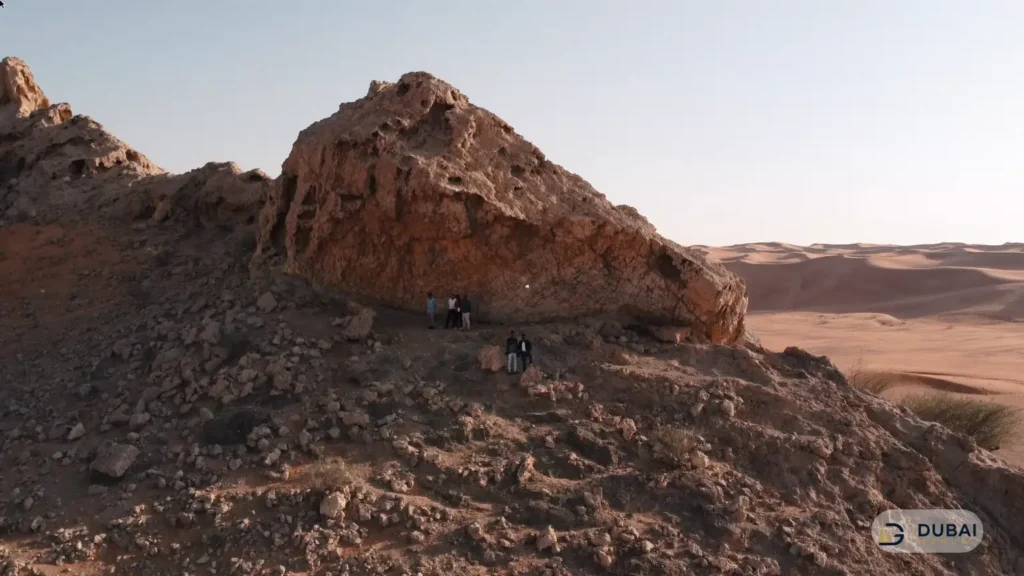 Fossil Rock formation with visitors in the Sharjah desert