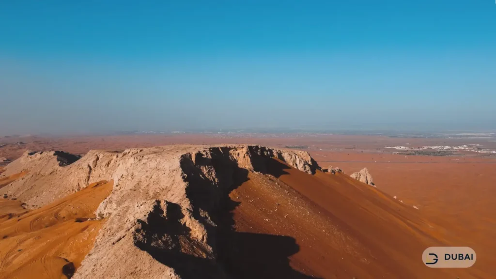 Fossil Rock outcrop and red dunes in Sharjah's Central Region