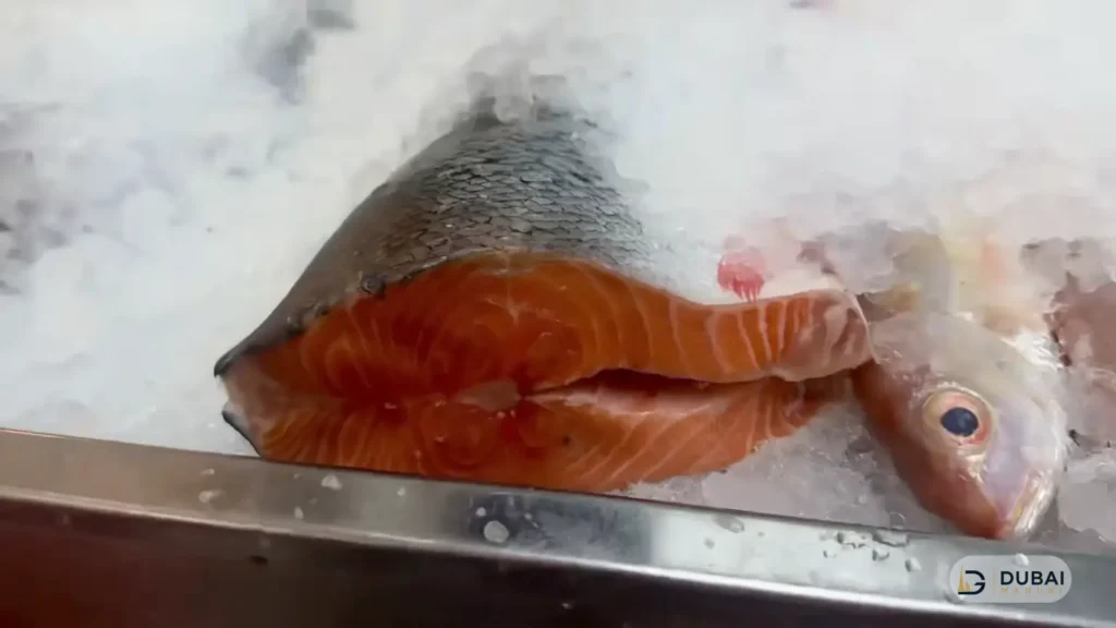 Fresh salmon fillets on ice at Karama fish market