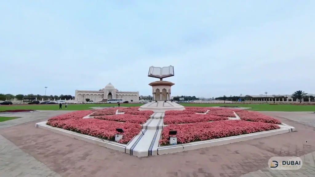 Holy Quran monument with red flower beds at Cultural Square Sharjah