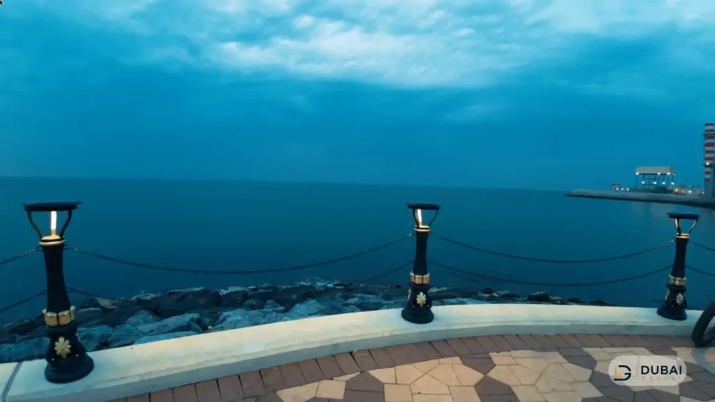 Illuminated lamp posts along the rocky breakwater at Al Layyah Canal