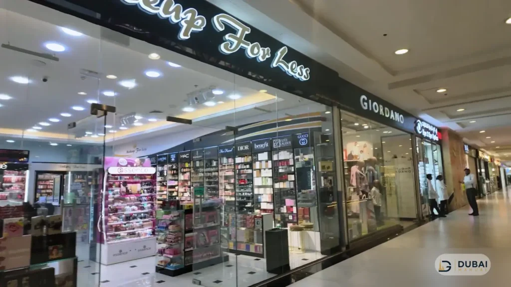 Makeup For Less and Giordano storefronts inside the Century Mall corridor