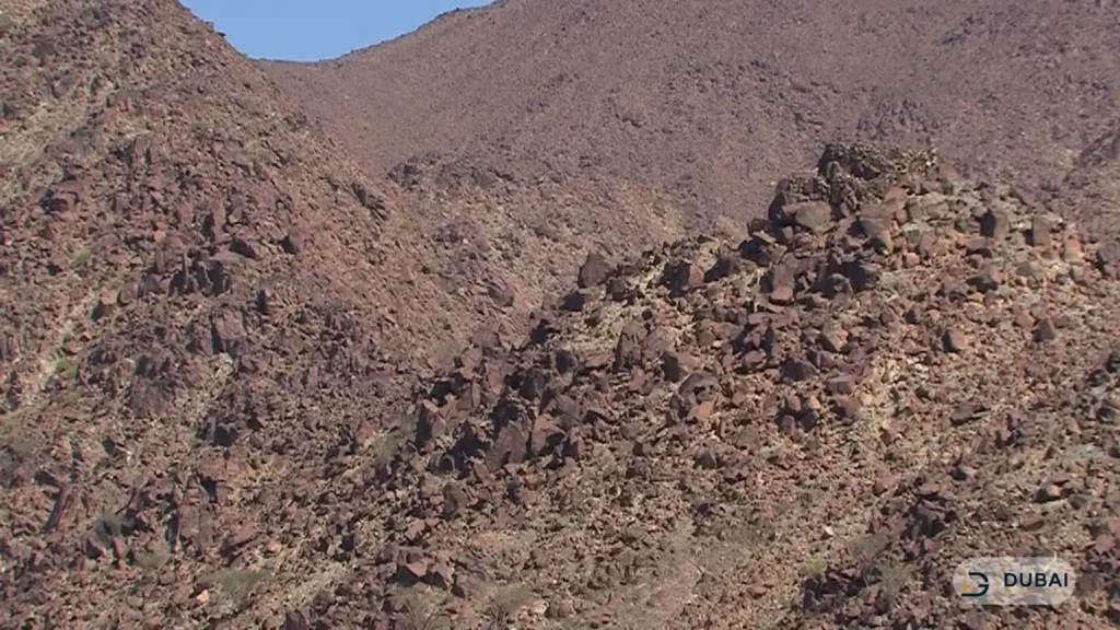 Rocky mountain slopes along the Wadi Al Helo hiking terrain