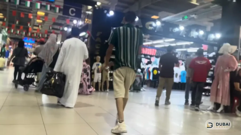 Shoppers browsing clothing stores inside Ajman China Mall